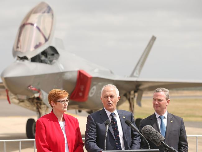 PM Malcolm Turnbull, cetre, with Defence Minister Marise Payne and Minister for Defence Industry Christopher Pyne after inspecting a Joint Strike Fighter (JSF) F-35 at the Avalon Airshow. Picture: Scott Barbour.