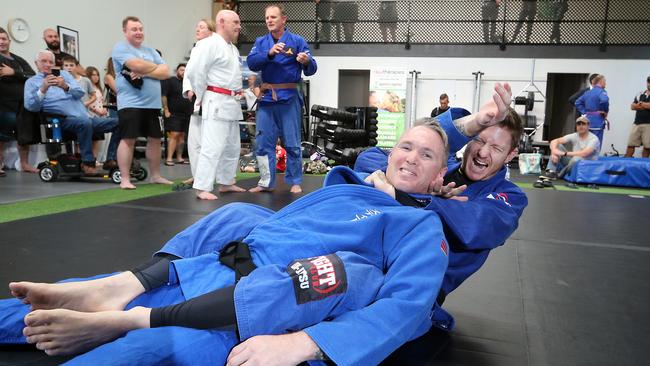 Luke Meir on the mat with Veteran Grappling founder Scott Steer (front).