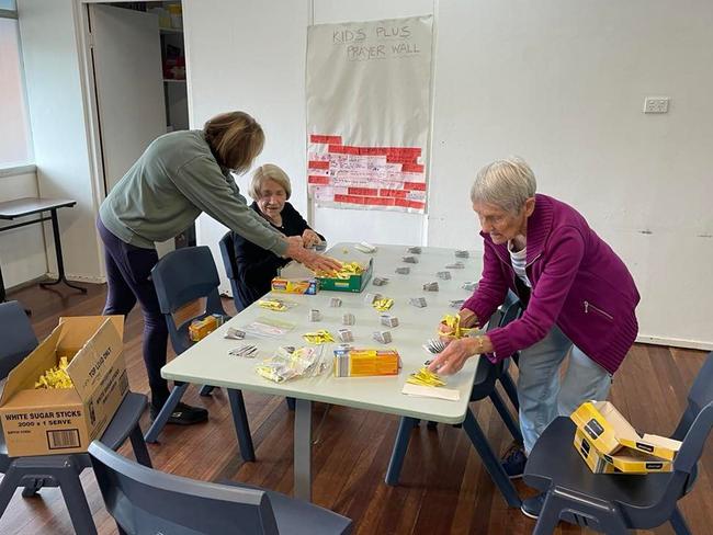 (From left) Jenny Moreny, Eunice Auer and Val Messer hard at work preparing tea kits for the care packages distributed by the parish.