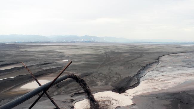 Black sludge is pumped into a toxic lake — byproducts of the ingredients that make up most of our technology. Picture: Liam Young/Unknown Fields.