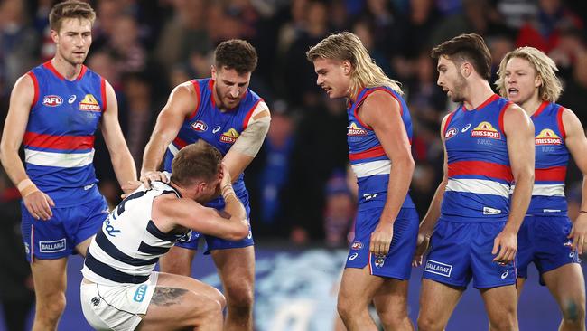 Zach Tuohy grabs his head after the contact from the Bulldogs star. Picture: Michael Klein