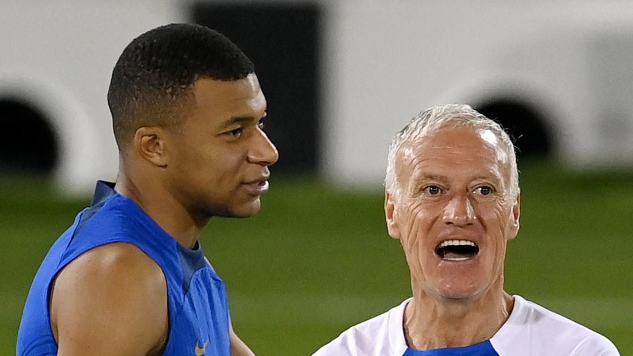 France's head coach Didier Deschamps (R) reacts next to France's forward Kylian Mbappe (L) during a training session.