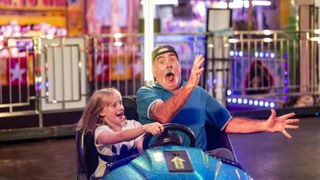 Ruby Hopkinson takes granddad Peter Desmond for a crazy ride on the dodgem cars at Toowoomba Royal Show, Thursday, March 30, 2023. Picture: Kevin Farmer