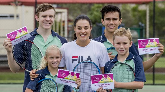 Kim Birrell delivers tickets to Coomera Anglican College students who joined her on court. Left to right: Baxter Dent, Emerson Jones, Lucas Crummer and Hayden Jones, with Birrell in the middle. Picture: Jerad Williams