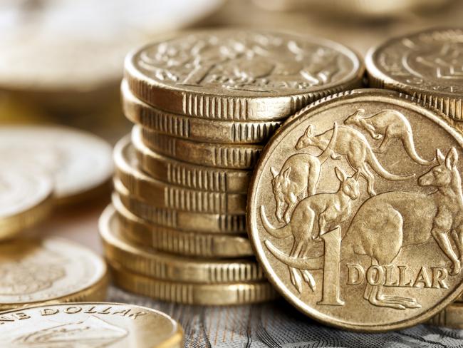 Stacks of Australian one dollar coins.  Focus on front coin. Australian cash, money generic