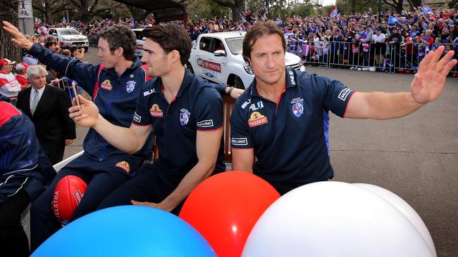 Bob Murphy, Easton Wood and Luke Beveridge wave to the crowd during the 2016 Grand Final Parade. Picture: Stuart McEvoy