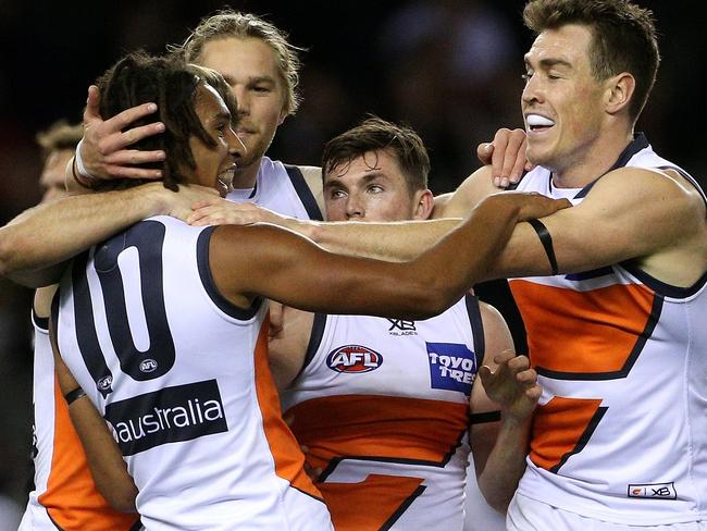 Aiden Bonar of the Giants (left) celebrates his first AFL goal with team mates during the Round 20 AFL match between the Carlton Blues and the Greater Western Sydney (GWS) Giants at Etihad Stadium in Melbourne, Sunday, August 5, 2018. (AAP Image/Hamish Blair) NO ARCHIVING, EDITORIAL USE ONLY