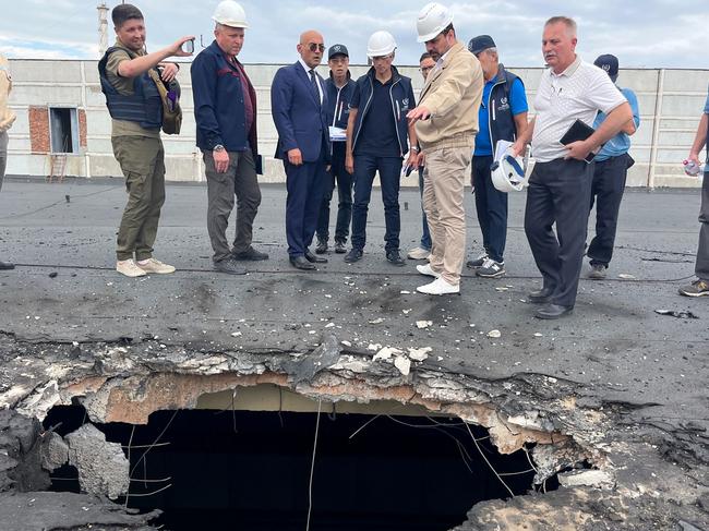 International Atomic Energy Agency staff survey a building at the Zaporizhzhia plant damaged by shelling. Picture: Fredrik DAHL / International Atomic Energy Agency / AFP