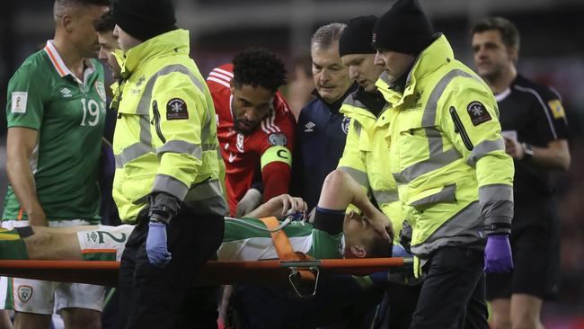 Ireland's Seamus Coleman is taken off the pitch injured.