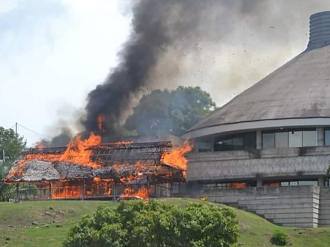 A building burning next to the parliament building in Honiara on Solomon Islands. Picture: Courtesy of Charley Piringi / AFP