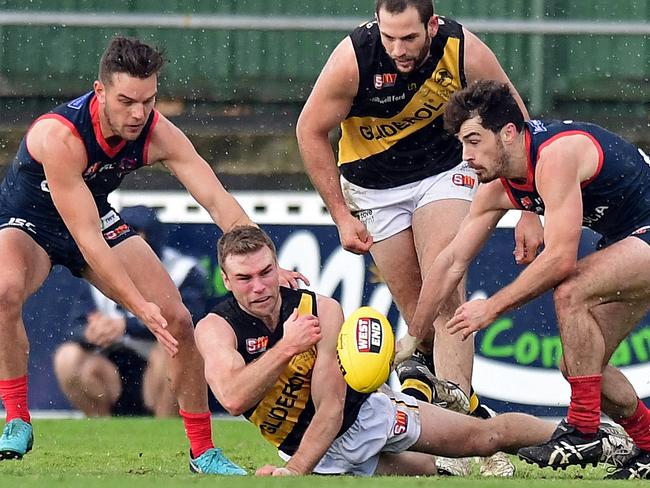 16/06/18 - SANFL: Norwood v Glenelg at Norwood Oval.  Glenelg's Andrew Bradley fires out a handpass.Picture: Tom Huntley