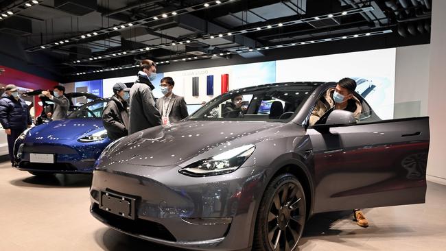 People look at a Tesla Model Y car at a Tesla showroom in Beijing. Picture: AFP