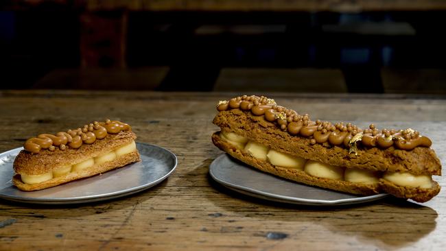 The new super-sized salted-caramel eclair and the regular-sized caramel eclair — both on the same sized plate. Picture: Jerad Williams