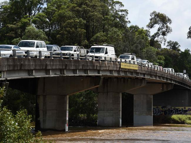 GOLD COAST, AUSTRALIA - NewsWire Photos DECEMBER 15 2020: Local at Tumbulgum park their cars on high ground on the bridge as flooding and wild weather battered south-east Queensland and north-east NSW. Picture: NCA NewsWire / Steve Holland