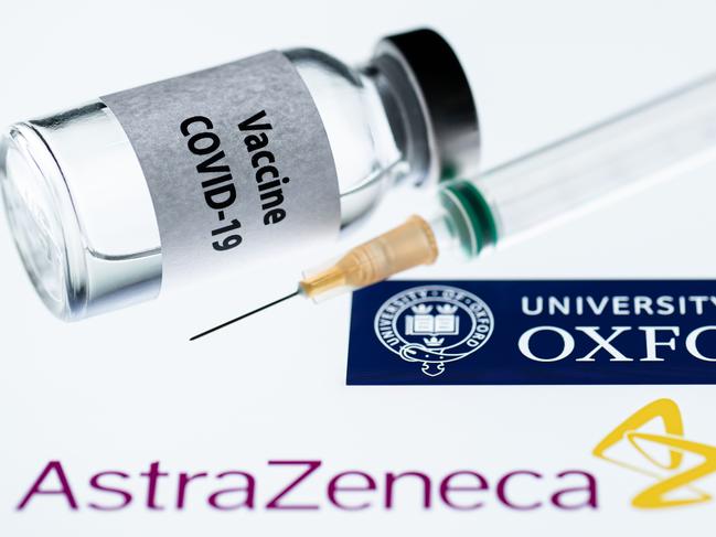 This illustration picture taken in Paris on November 23, 2020 shows a syringe and a bottle reading "Covid-19 Vaccine" next to AstraZeneca company and University of Oxford logos. (Photo by JOEL SAGET / AFP)