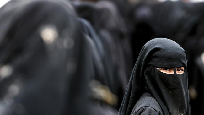 A woman, living in al-Hol camp which houses relatives of Islamic State group members, looks back in the camp. Picture: AFP