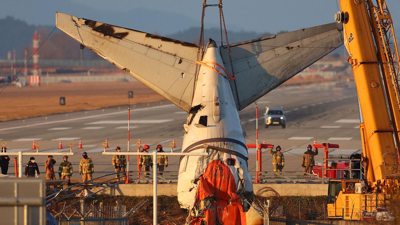 A crane lifts the tail section during the salvage operation of the Jeju Air aircraft. Picture: Yonhap/AFP