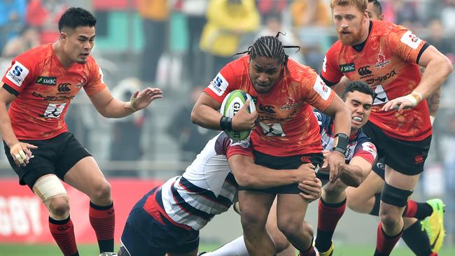 Sunwolves WTB Mifiposeti Paea (C) is tackled by Rebels players CTB Mitch Inman (2nd L) and SO Jack Debreczeni (2nd R) during the round-four Super Rugby league match between Japan Sunwolves and Rebels from Australia at the Prince Chichibu Memorial Rugby Ground in Tokyo on March 19, 2016. / AFP PHOTO / KAZUHIRO NOGI