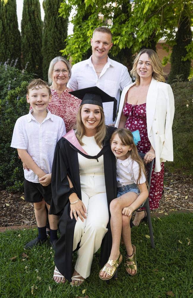 Bachelor of Education (Secondary) with distinction graduate Rebecca Boisen celebrates with (from left) Archer Boisen, Margaret Mills, Alex Boisen, Evie Boisen and Debbie Mills at a UniSQ graduation ceremony at The Empire, Tuesday, October 29, 2024. Picture: Kevin Farmer