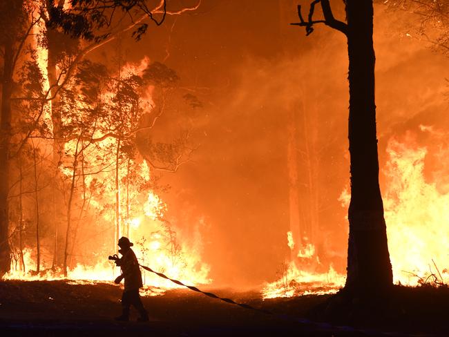 A bushfire encroaching on properties near Termeil on the Princes Highway between Batemans Bay and Ulladulla south of Sydney in December last year Picture: Dean Lewins