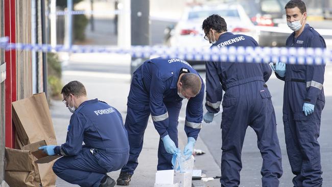 Forensic police examine items at the scene of a shooting outside Love Machine nightclub. Picture: AAP