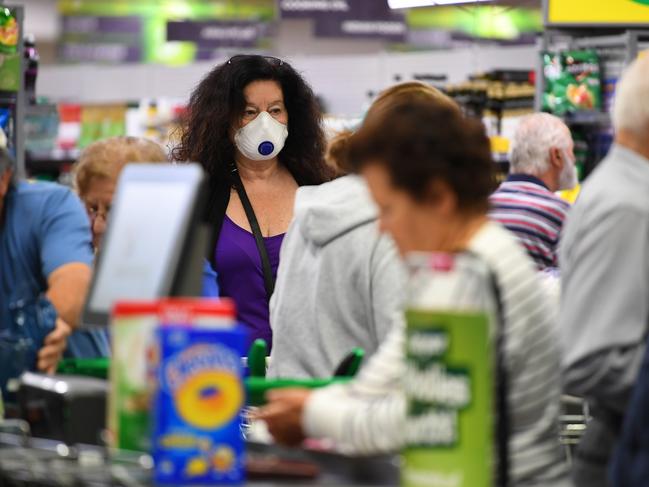 A woman wears a face mask at a Woolworths supermarket in Coburg, Melbourne. Picture: AAP Image/James Ross