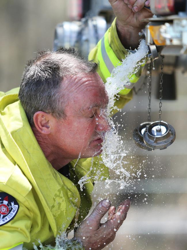 Firey Rod Watts gets some relief after battling fires south of Taree. Picture: Peter Lorimer