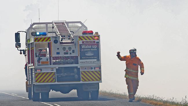 Fire fighters look to contain a fire along Elderslie Road in Elderslie. Picture: Zak Simmonds