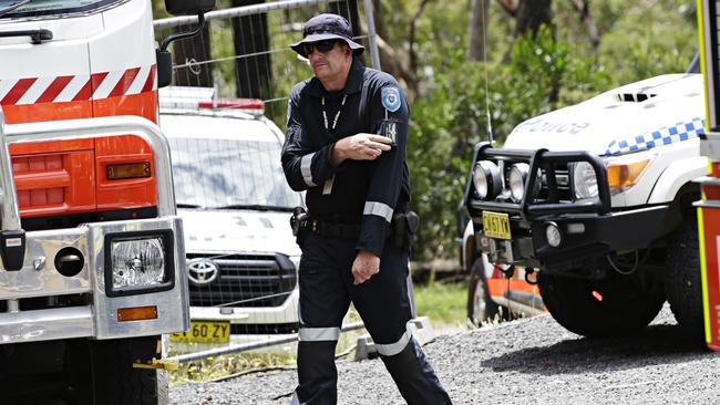 Police pilot returning to his helicopter to go and collect the bodies. Picture: Adam Yip