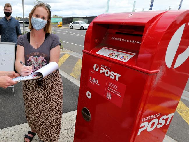 A petition urging Australian Post to build a post office in Armstrong Creek. Corangamite MP Libby Coker (left) launched the petition and was be at the Waralily Shopping Centre in Armstrong Creek to collect signatures. Local Maria Ainscough signs the petition, also there was Jack Williams helping collect signatures. Picture: Mike Dugdale