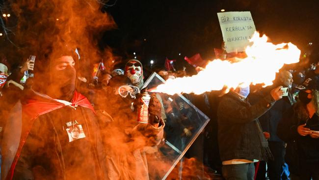 A protestor uses a gas spray and a lighter during clashes with Turkish anti-riot police officers as part of a rally in support of Istanbul's arrested mayor in Istanbul Municipality, on March 23, 2025. Istanbul's newly-deposed mayor Ekrem Imamoglu was taken to a jail on the western outskirts of the megacity city on March 23, 2025 afternoon, the main CHP opposition party said. (Photo by YASIN AKGUL / AFP)