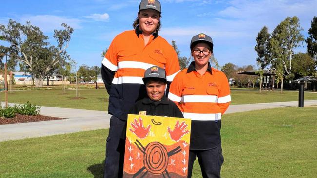 YOUNG TALENT: Zach Giddins and Eva Courte from MPC Kinetic Miles with Damien Roma and his winning artwork. Picture: Kate McCormack