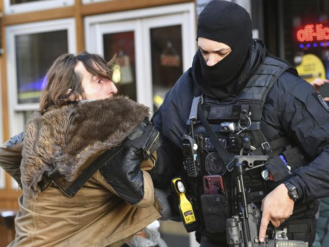 A police officer moves an uninvolved person away from a cordon after the London Bridge incident. Picture: Dominic Lipinski/AP