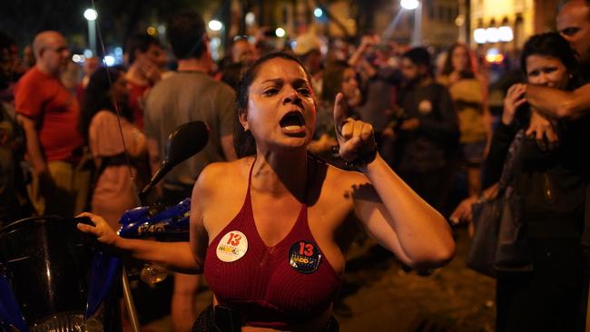 Things get heated for a supporter of Fernando Haddad in Rio de Janeiro. Picture: AP