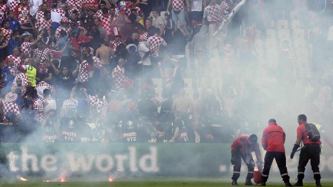 Flares are thrown on the pitch.