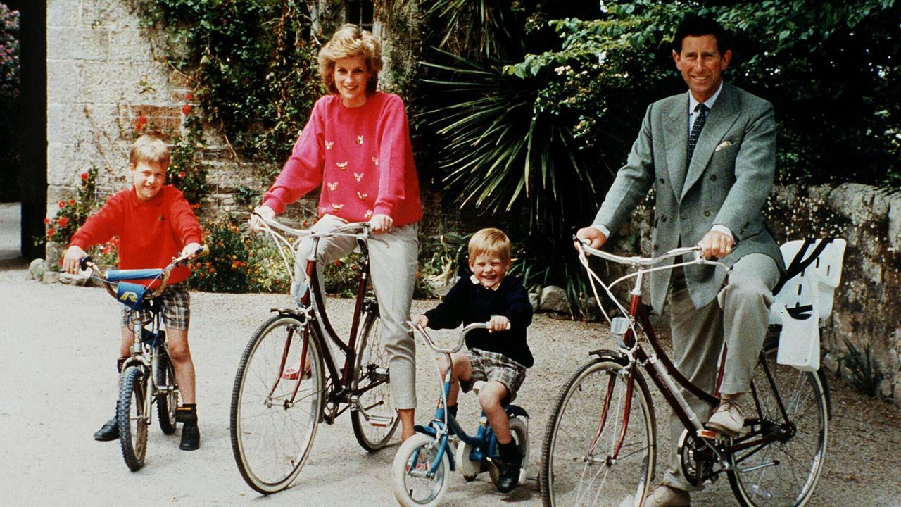 Diana and Charles ride their bikes with the boys.