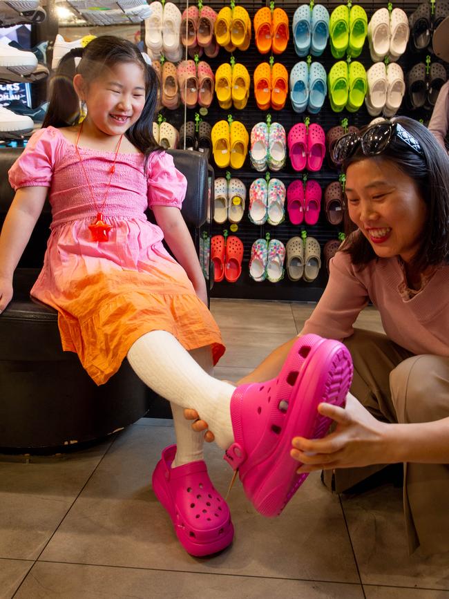 Yiyi tries on a pair with mum Aly Zhang at Platypus in Rundle Mall. Picture: Brett Hartwig