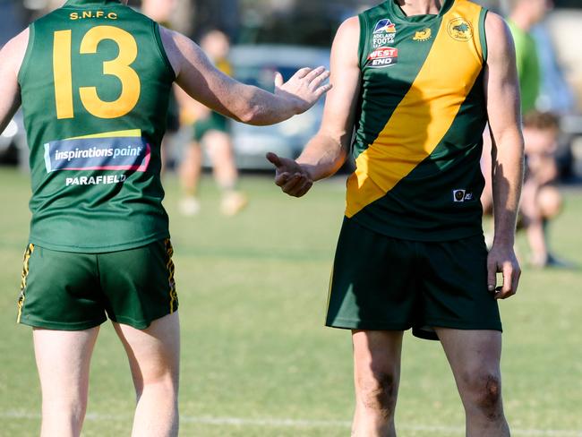 Dion Lawlor and Paul Marschall low-fiving during the Adelaide Footy League division two match between Salisbury North and Athelstone at Salisbury North Oval, Adelaide, Saturday, June 1, 2019. (AAP Image/ Morgan Sette)