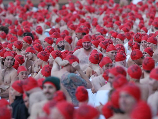DARK MOFO 2019: Participants of the nude solstice swim brave the cold water at dawn at Long Beach, Sandy Bay. Picture: LUKE BOWDEN