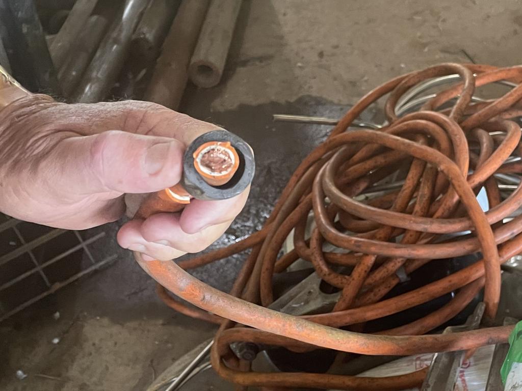 A cut cable of a MIG welder held by Zebra Metals business owner Ron Bowes as he reviewed the aftermath of meth-using burglars who caused over $100,00 in damages from their destructive behaviour at his Gracemere Industrial Estate premises.