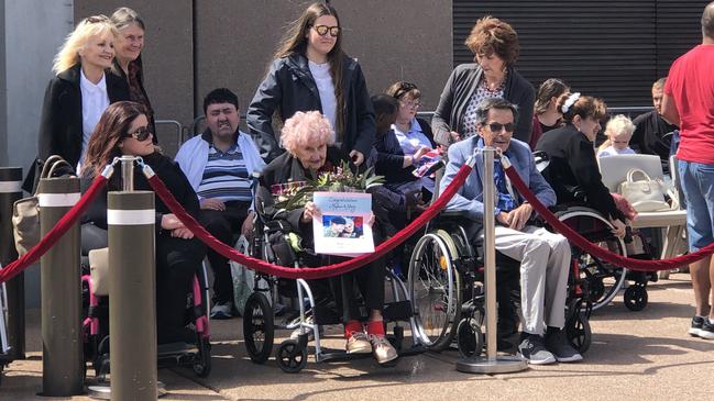 Daphne Dunne, centre, waiting patiently for the royal couple this morning.