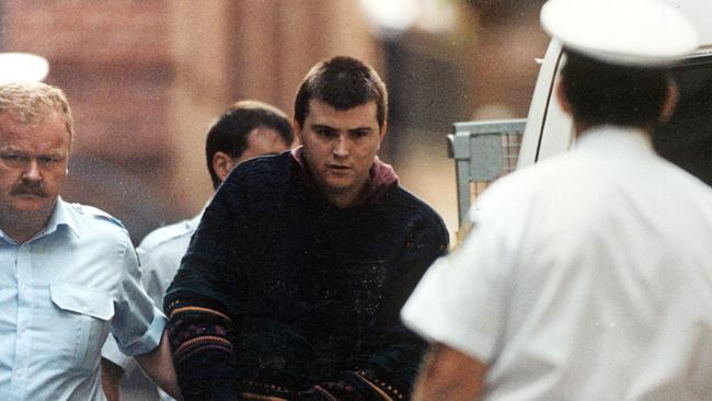 Frankston serial killer Paul Denyer is led away by police in 1993.