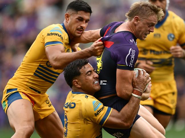 MELBOURNE, AUSTRALIA - MARCH 09:  Tyran Wishart of the Storm is tackled by Will Penisini and Dylan Brown of the Eels during the round one NRL match between the Melbourne Storm and the Parramatta Eels at AAMI Park on March 09, 2025, in Melbourne, Australia. (Photo by Quinn Rooney/Getty Images)