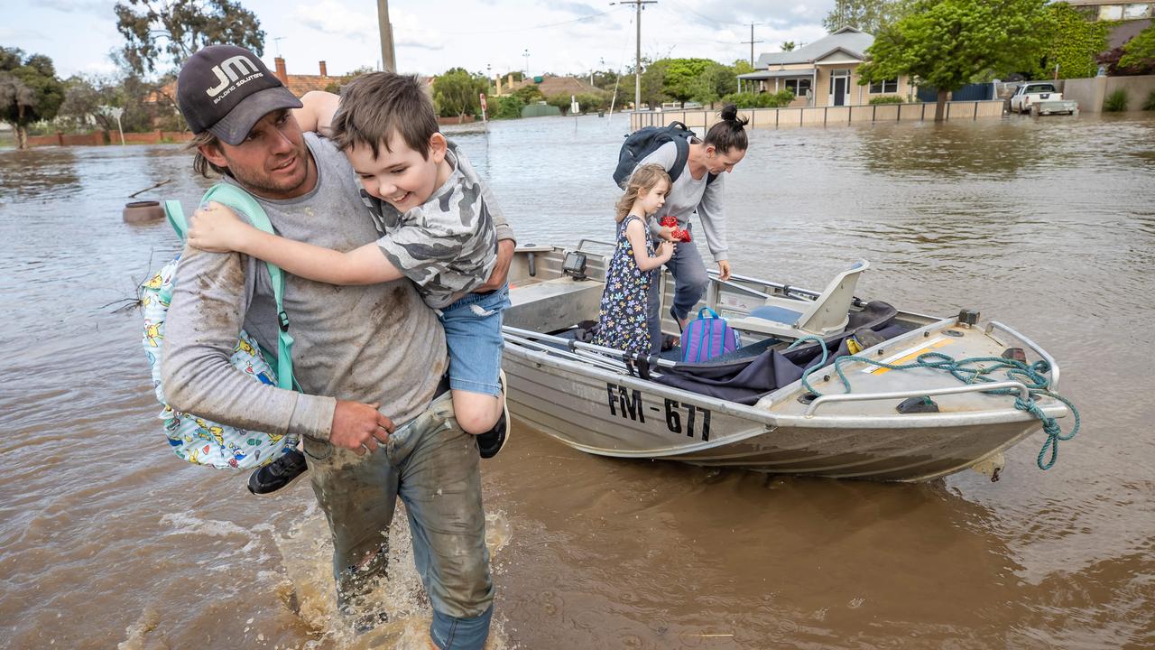 A family is rescued from their flooded home. Picture: Jason Edwards