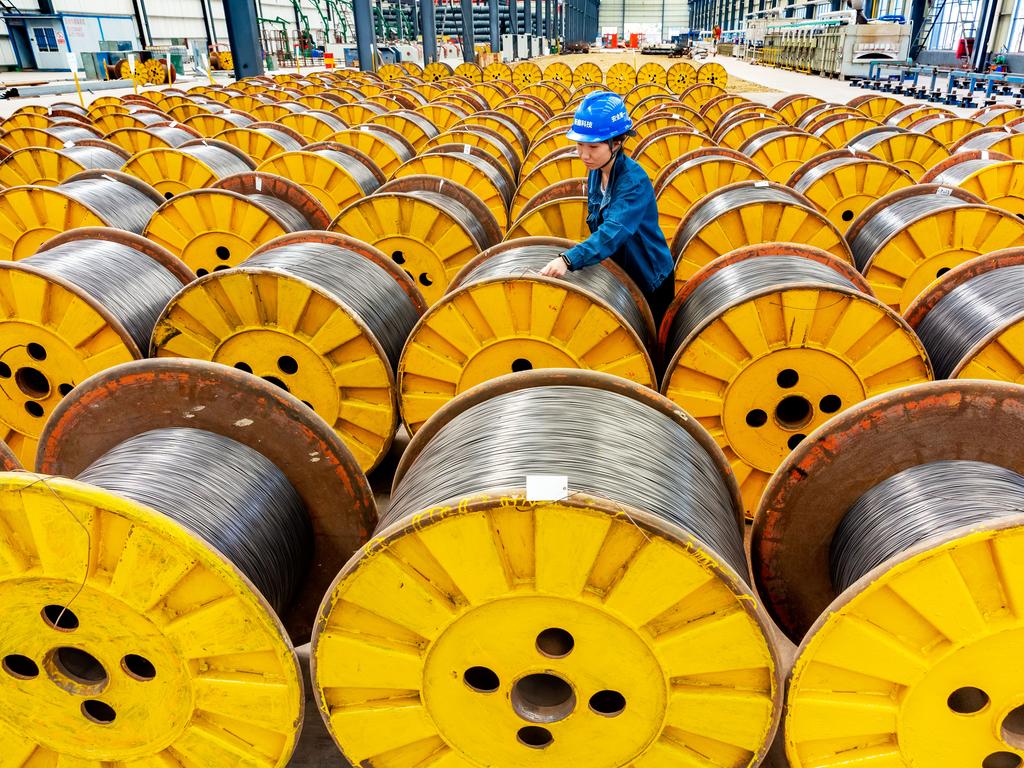 An employee inspects coils of steel rods at a factory in Xinyu, Jiangxi Province of China. Picture: Liu Zhiyong/VCG via Getty Images