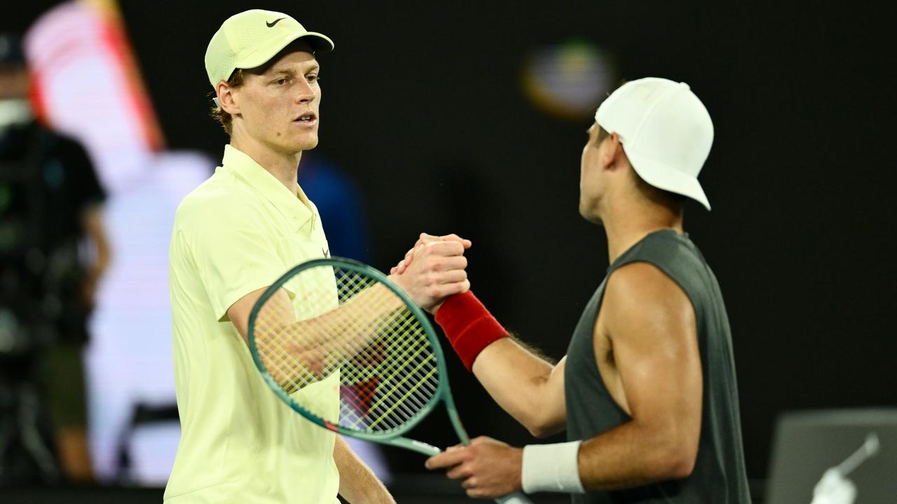 Jannik Sinner (left) shakes hands with Marcos Giron after the match. (Photo by Quinn Rooney/Getty Images)