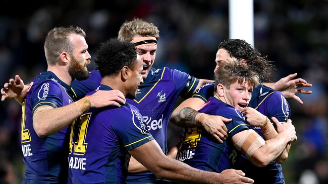 SUNSHINE COAST, AUSTRALIA - JUNE 19: Harry Grant of the Storm is congratulated by team mates after scoring a try during the round 15 NRL match between the Melbourne Storm and the Wests Tigers at Sunshine Coast Stadium, on June 19, 2021, in Sunshine Coast, Australia. (Photo by Bradley Kanaris/Getty Images)