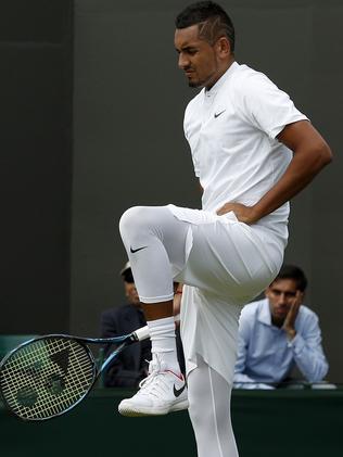 Nick Kyrgios stretches between points.