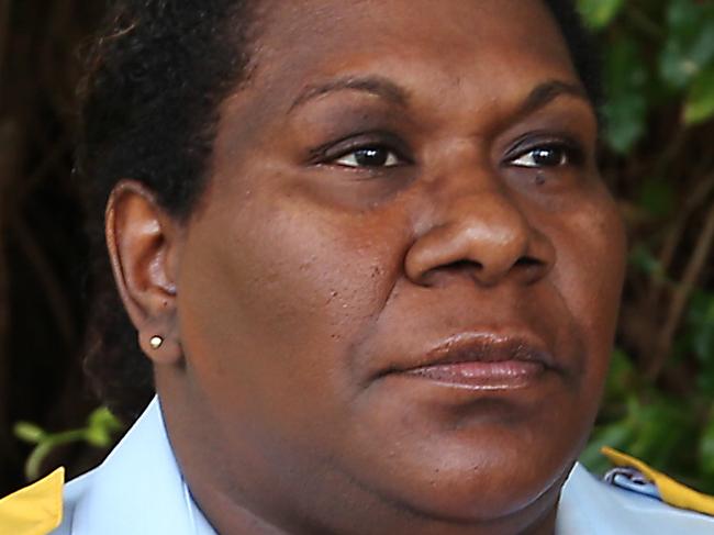 Police Liason Officer Kathy Lowah in front of a temporary memorial in Murray Street park for eight children who were stabbed to death in a nearby house. Picture: Brendan Radke.