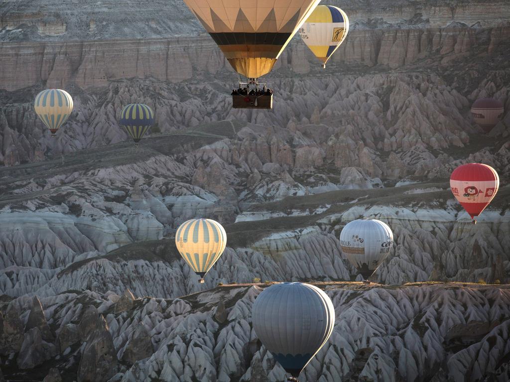 Tourists ride hot air balloons near the town of Goreme on April 17, 2016 in Nevsehir, Cappadocia, Turkey. Picture: Getty